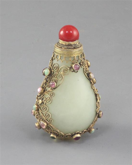 A Chinese pale celadon jade, silver gilt and cabochon gem mounted snuff bottle, early 20th century, total height 8cm